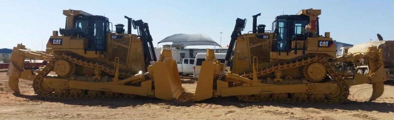 Two Cat D9T dozers parked blade to blade