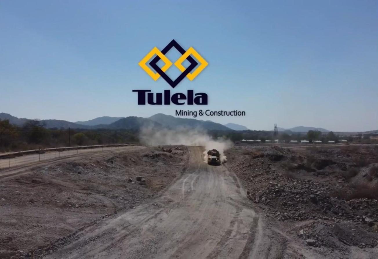 Tulela Mining & Construction logo over a haul road with a dump truck